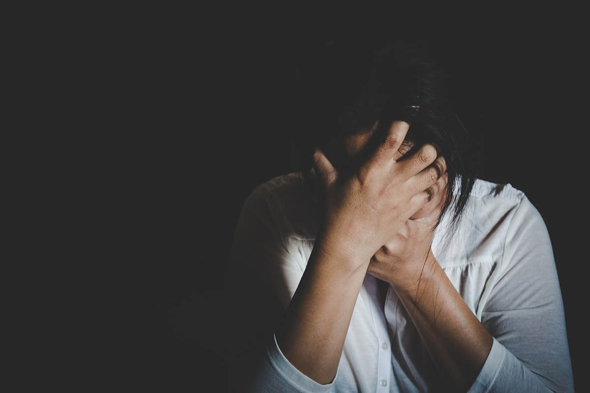 Man holding his head in his hands