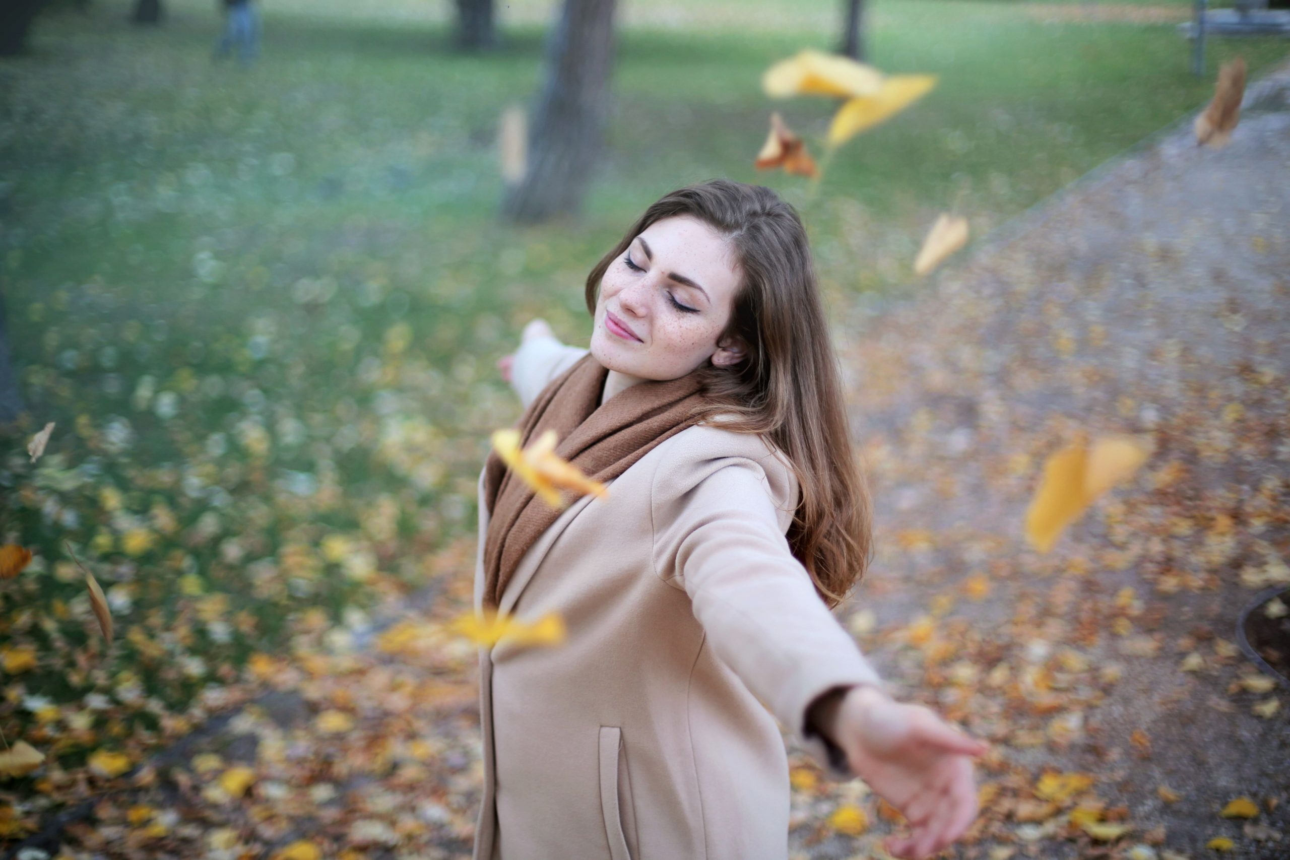 woman dancing in leaves