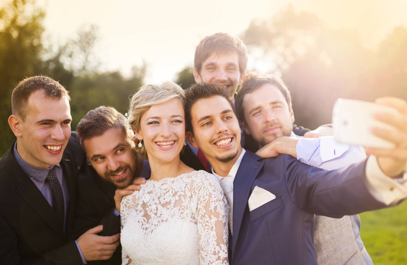 Wedding photo selfie with bride, groom, and groomsmen