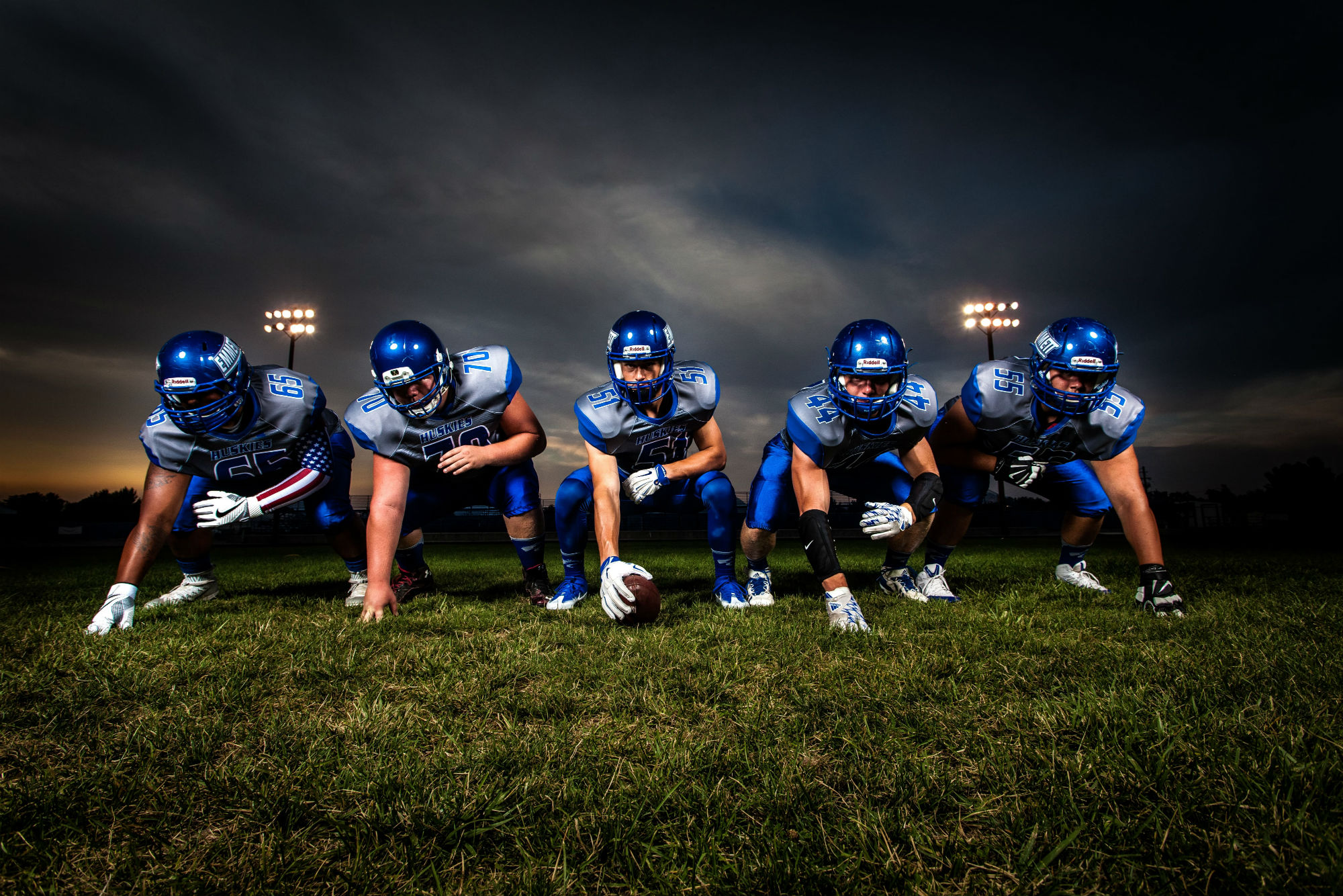 Football players in straight line in ready stance