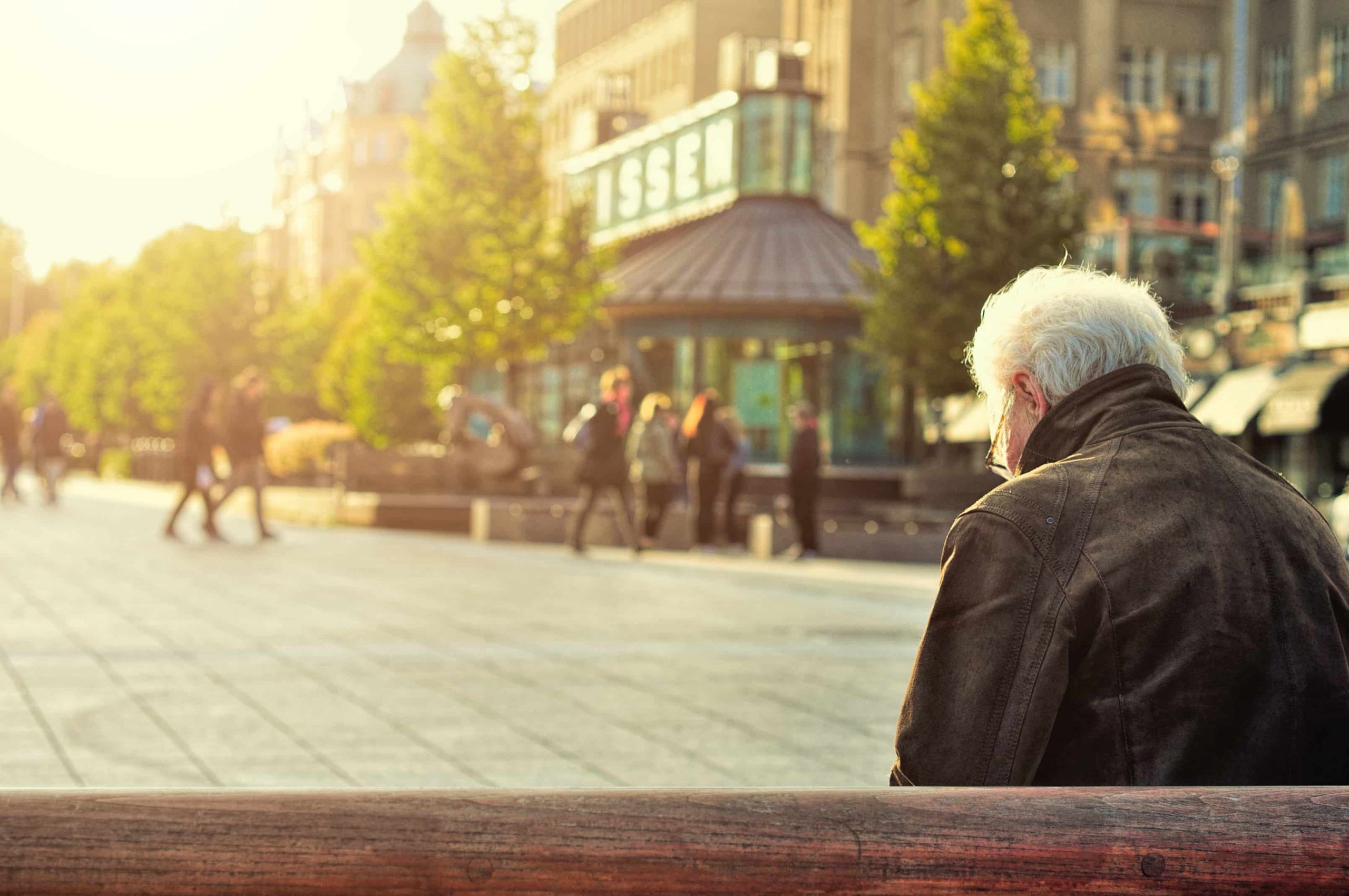 Older gentleman standing alone in the city