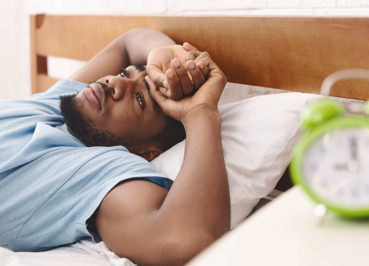 Man laying down on a bed