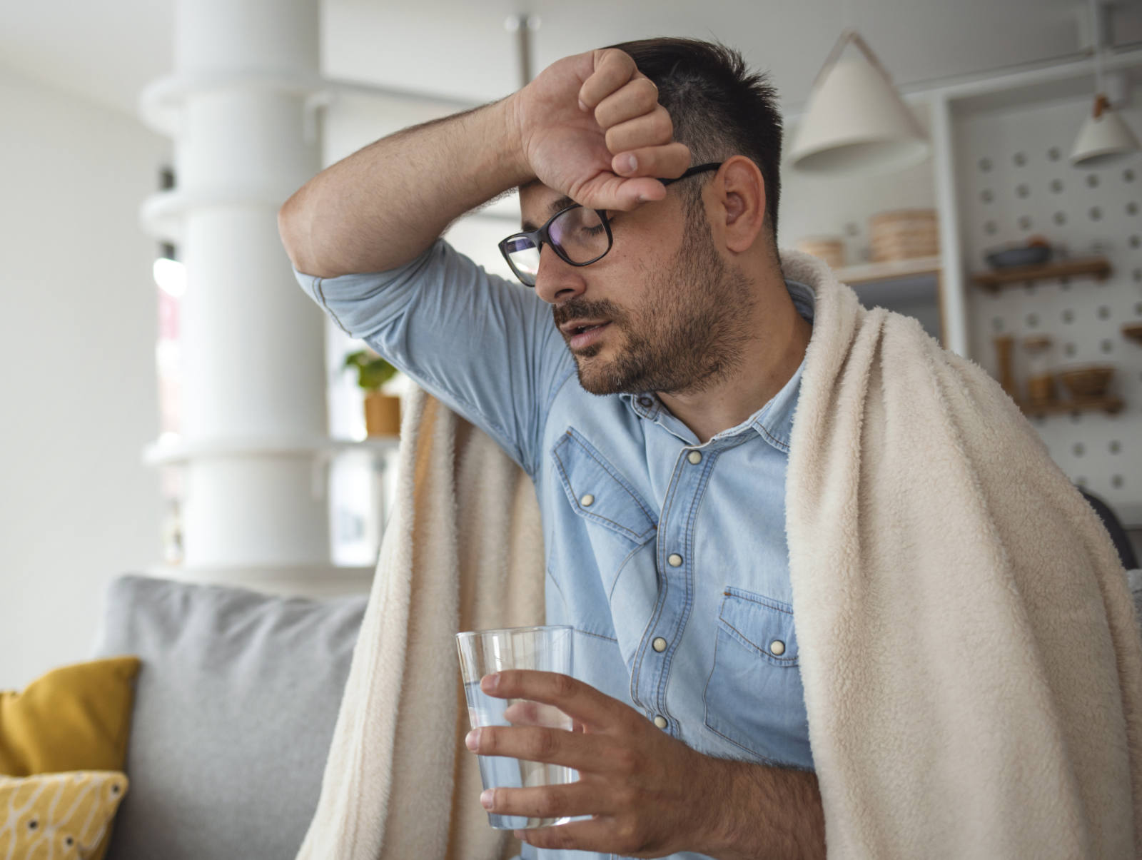 man drinking water looking distressed