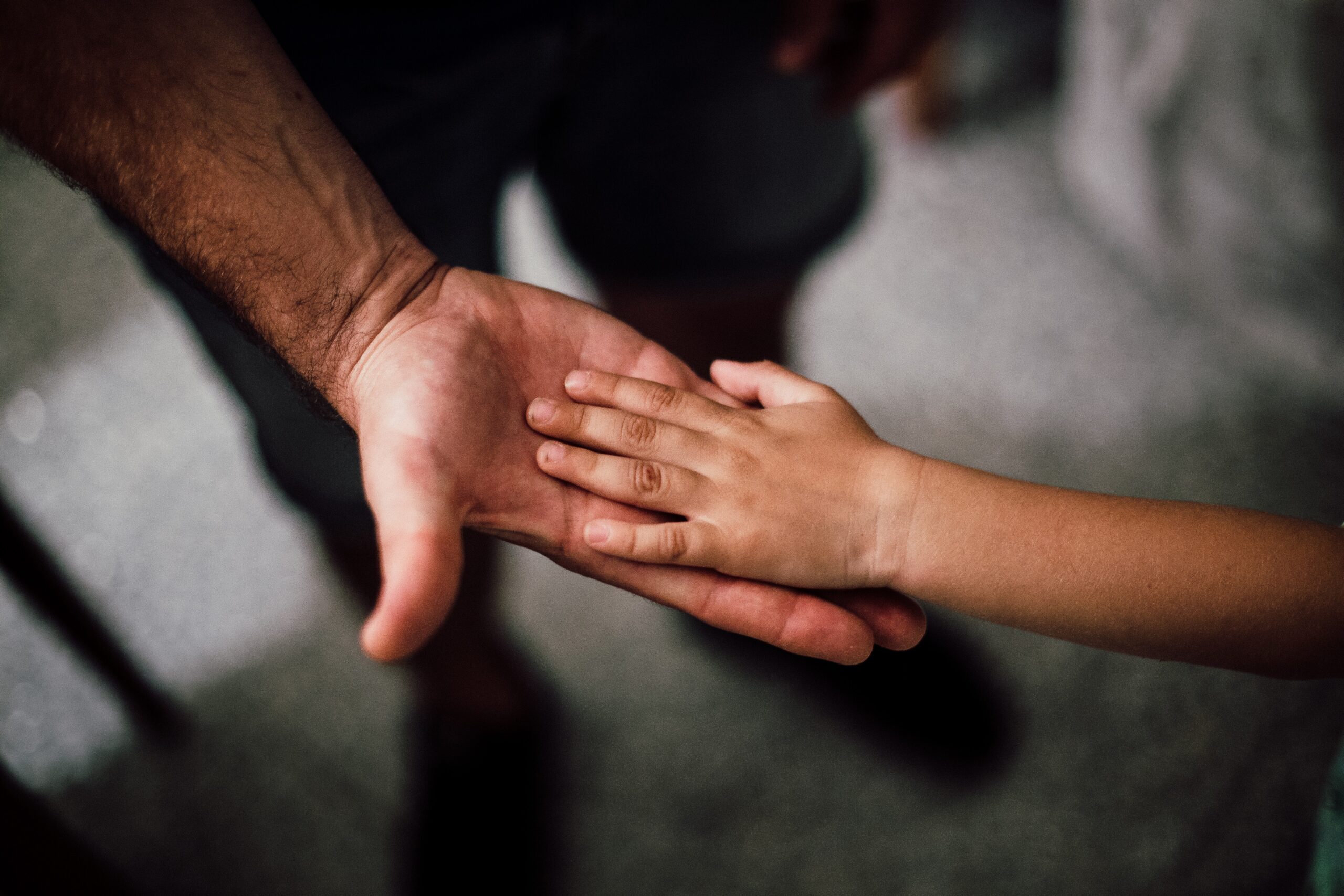 child holding parents hand