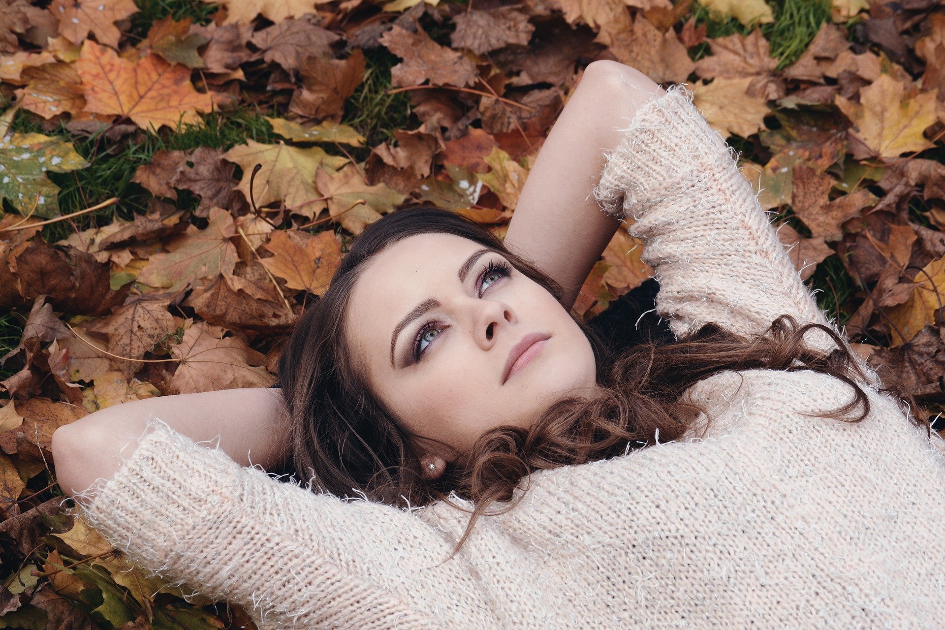 woman laying in leaves