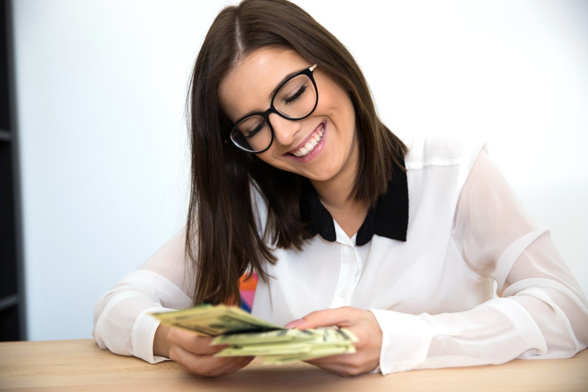 Woman smiling counting money