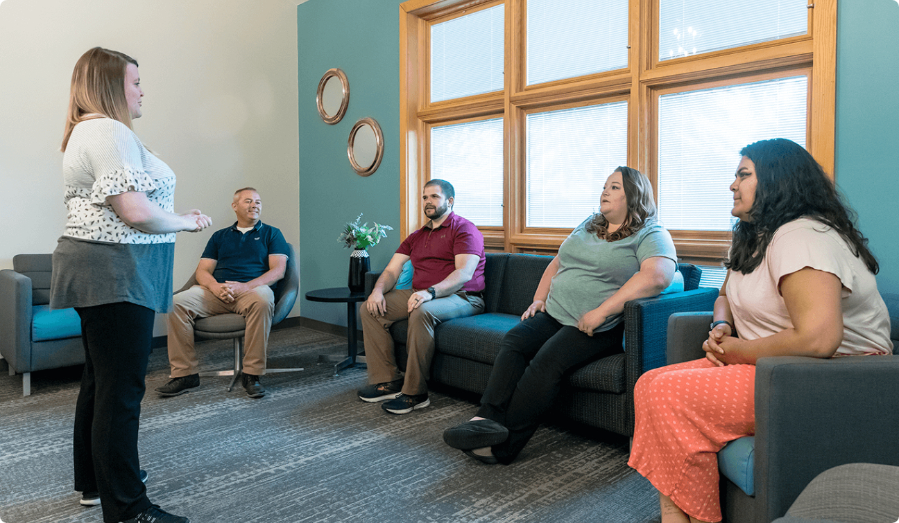 Group therapy session taken place in modern office