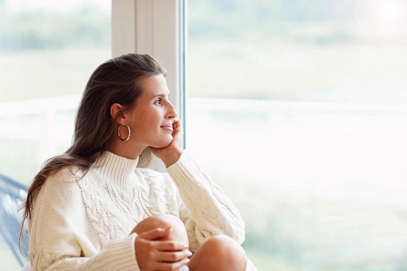 woman looking out a window