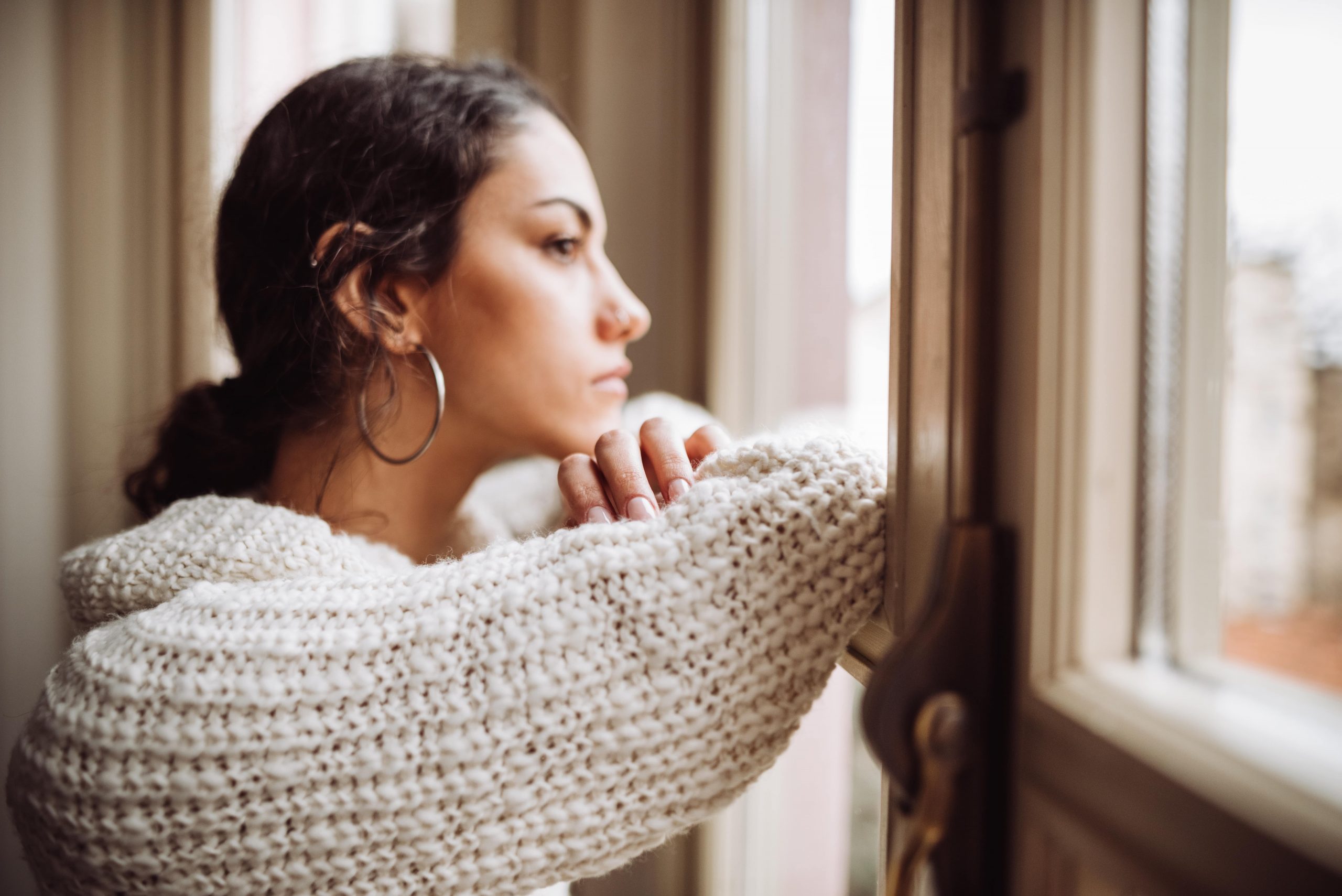 woman staring out the window