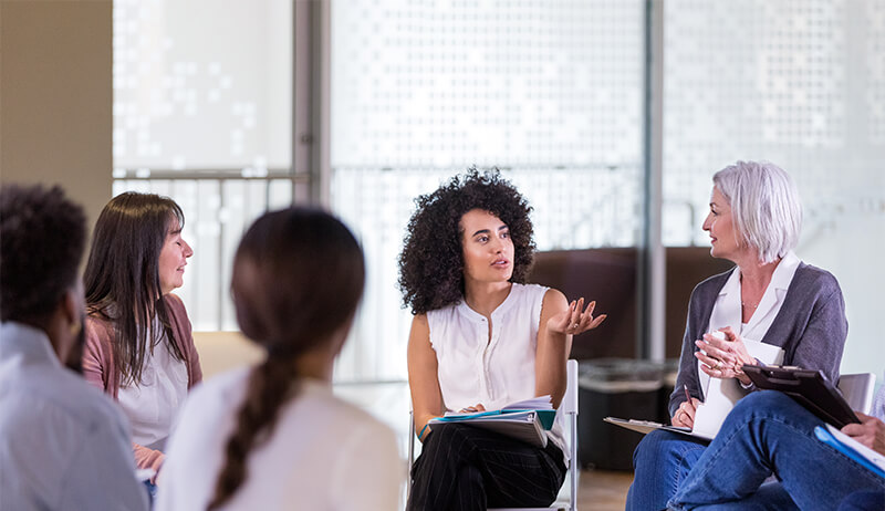 Woman speaking in a group therapy session