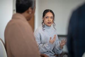 Woman leading discussion in a group therapy session