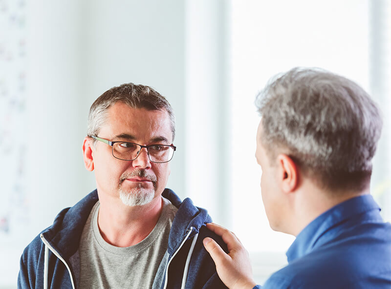 Therapist comforting his patient