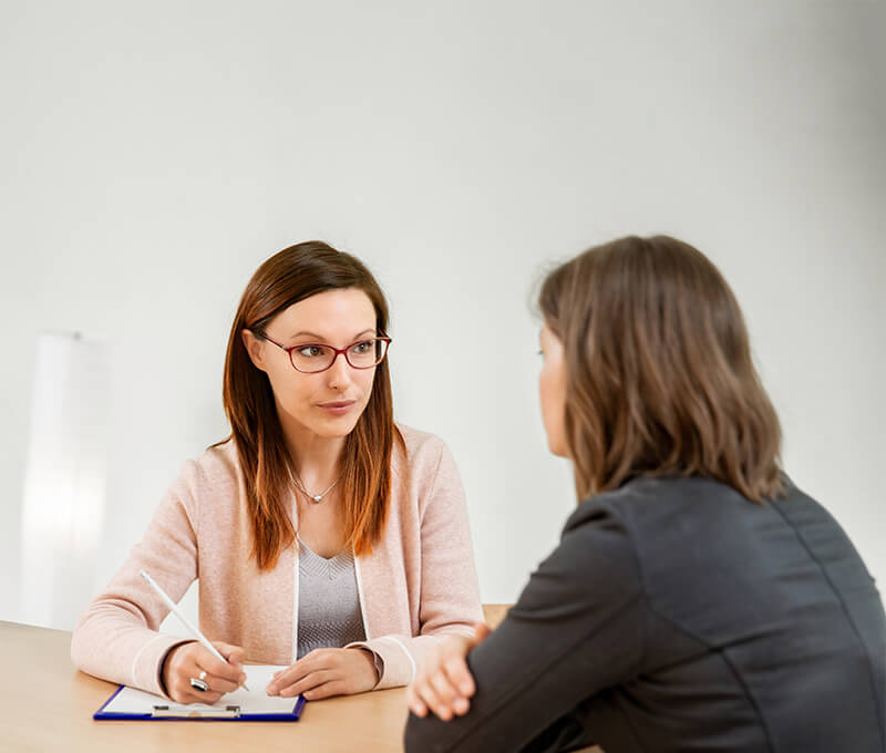 Therapist listening to patient and taking notes