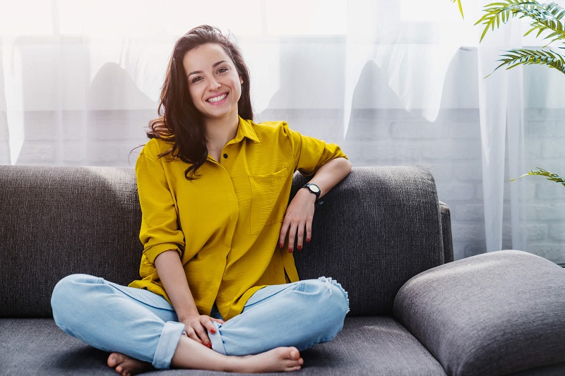 woman sitting down on a couch