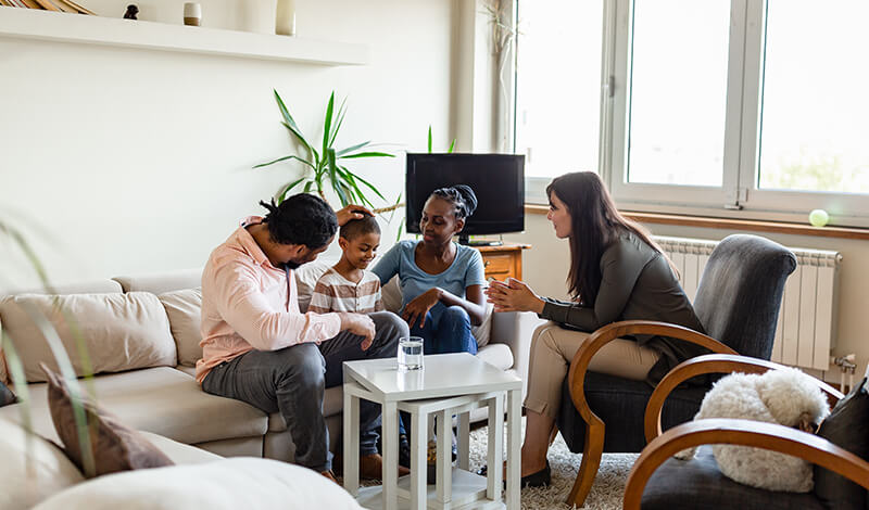 Family with a child meeting with a counselor