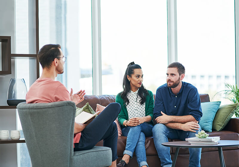 Two people speaking with therapist