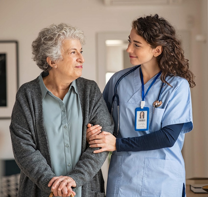 Therapist helping an older patient walk