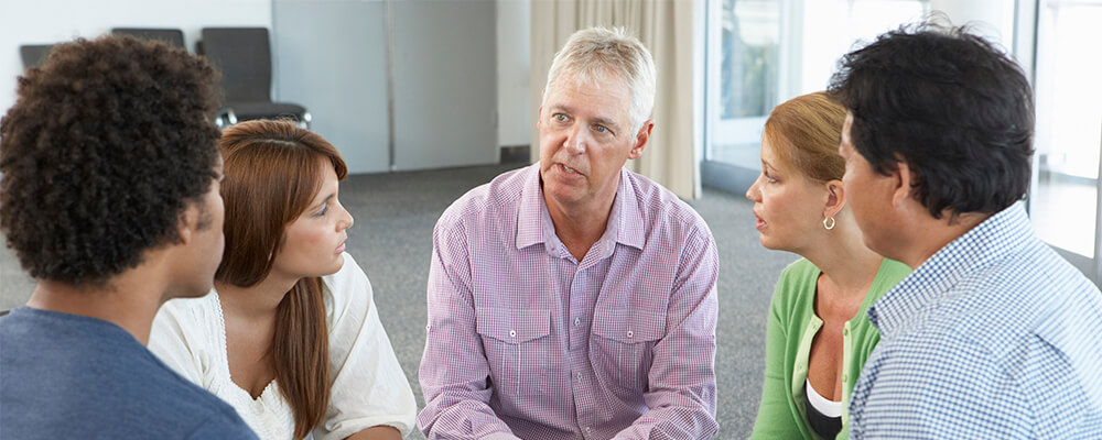 Man talking to a therapy group