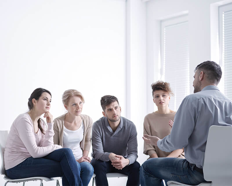 Man leading discussion on group therapy