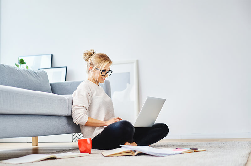 Woman using a laptop in her living room