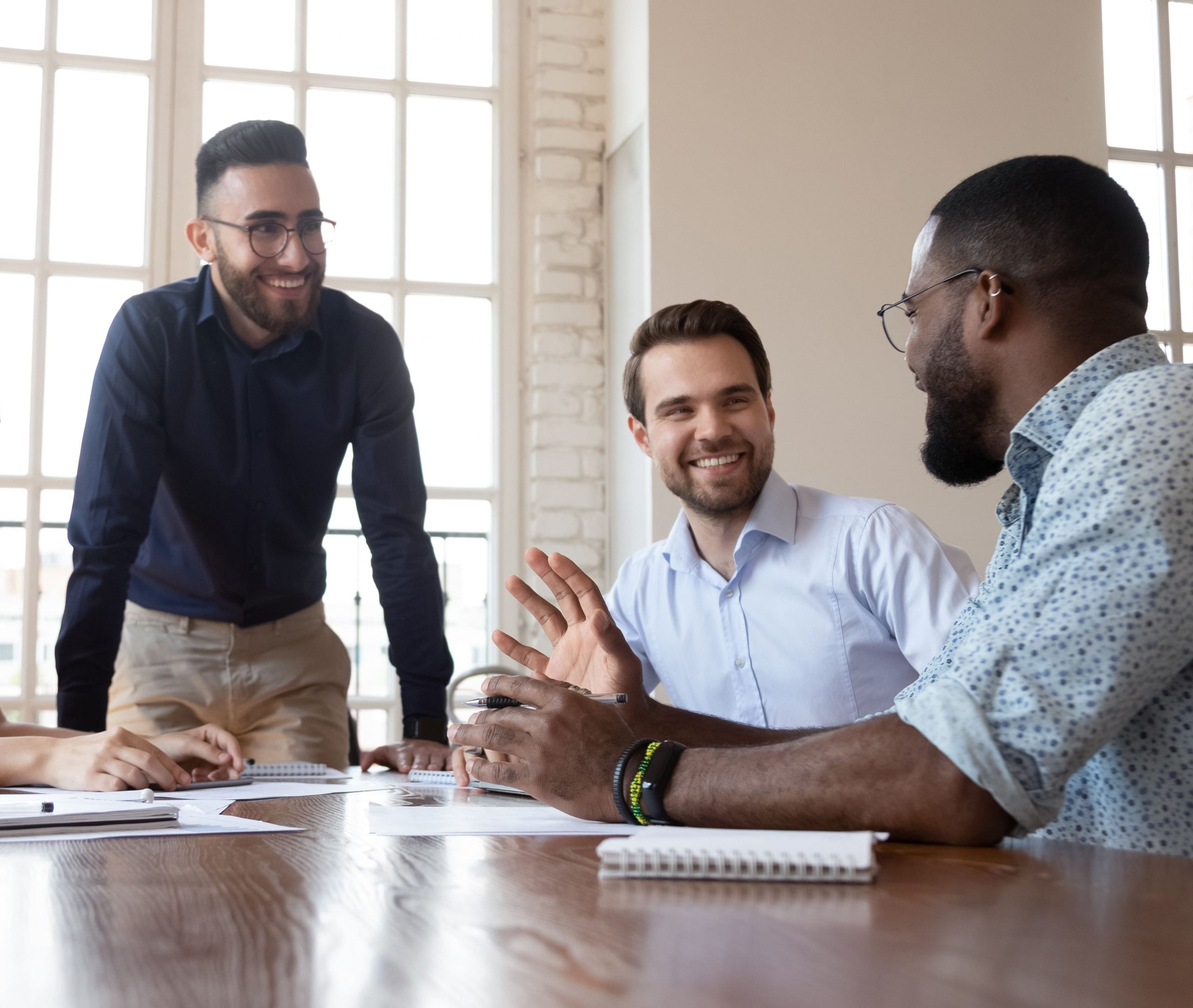 Group of male professionals talking in a meeting in a modern office