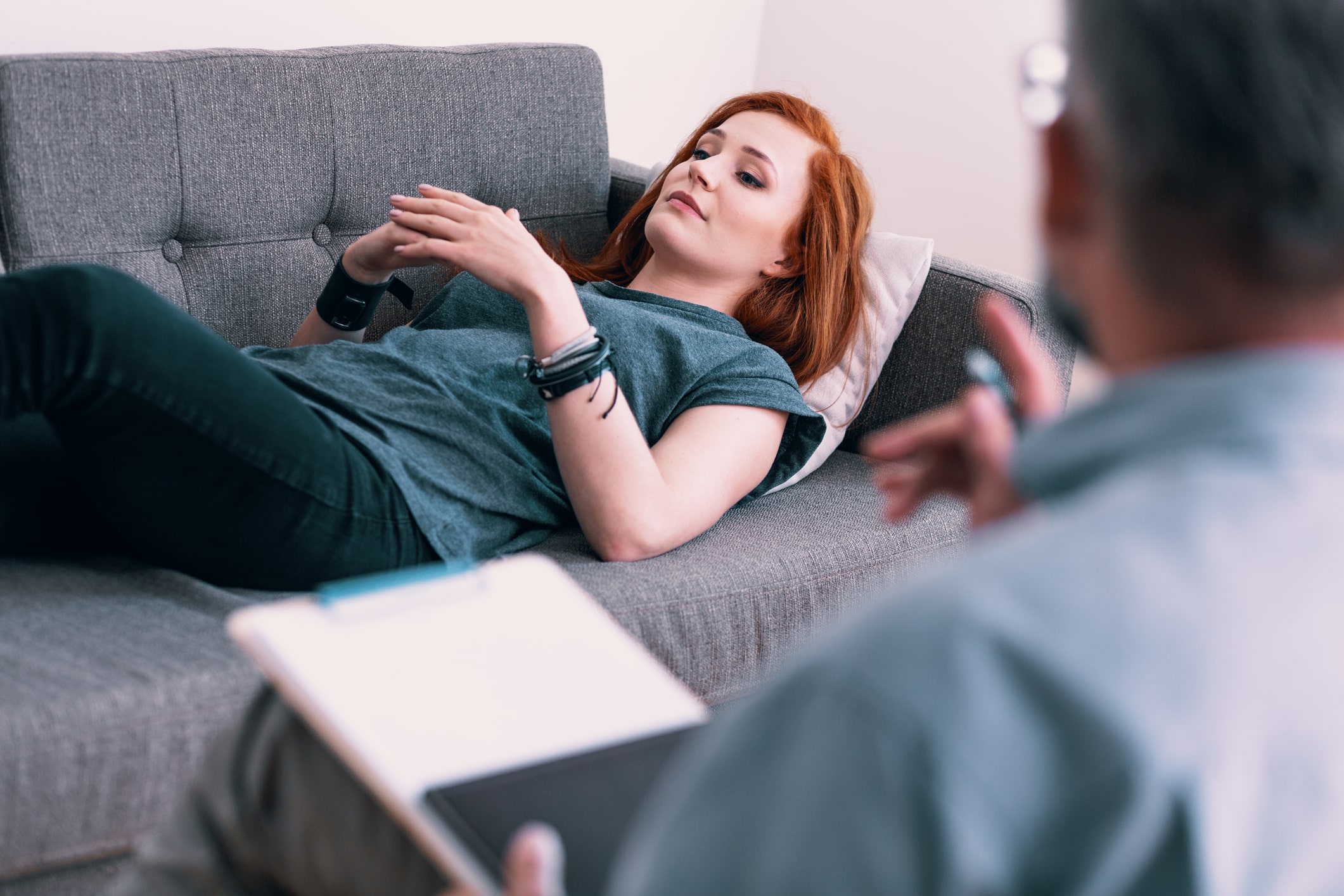 Doctor talking to his patient who is lying down