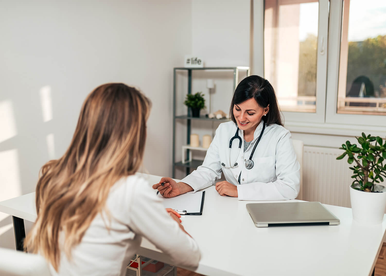 Doctor listening to patient and taking notes