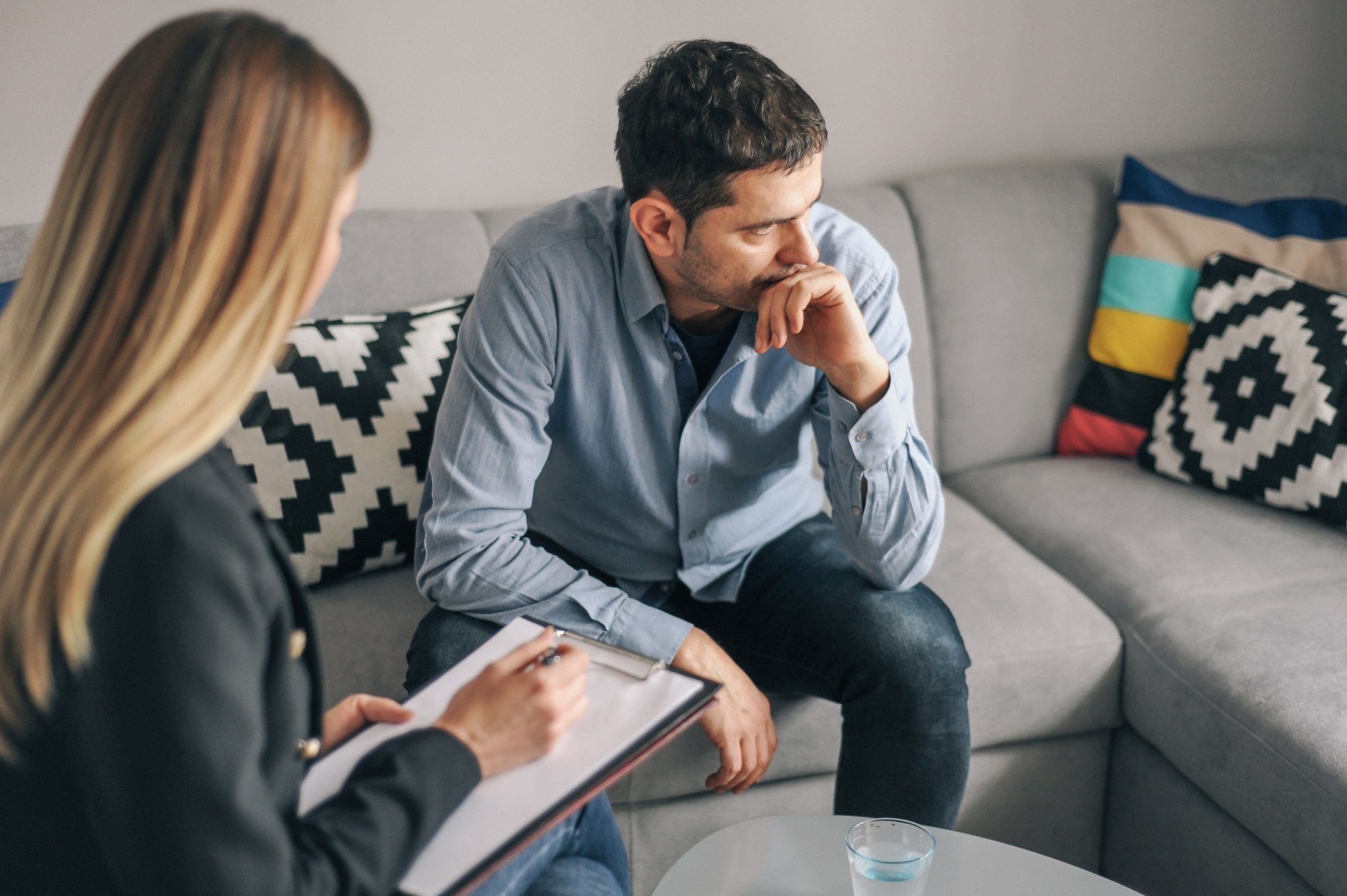 Doctor speaking with her patient sitting on a couch