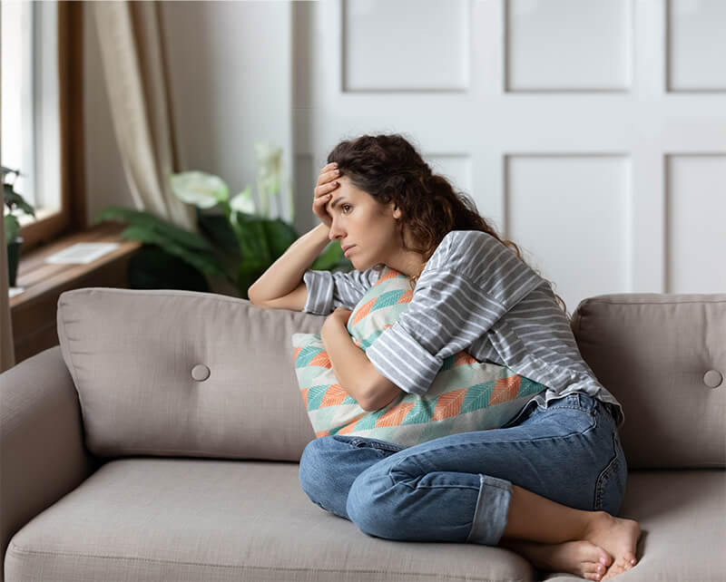 Depressed woman looking out window