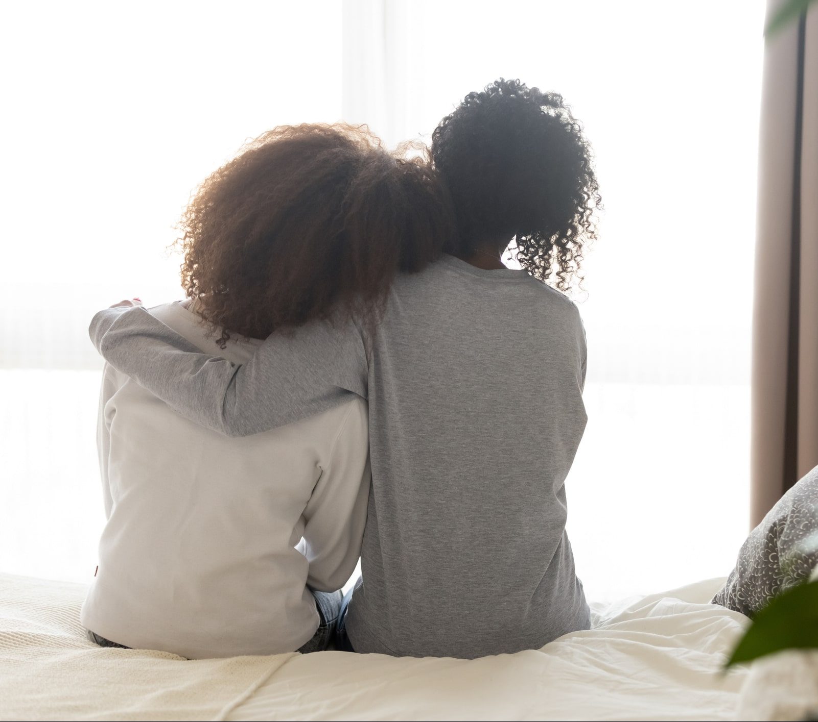 woman sitting embracing each other