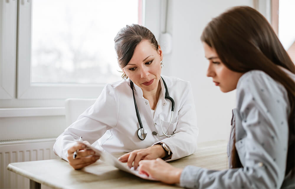 Doctor going over insurance information with patient