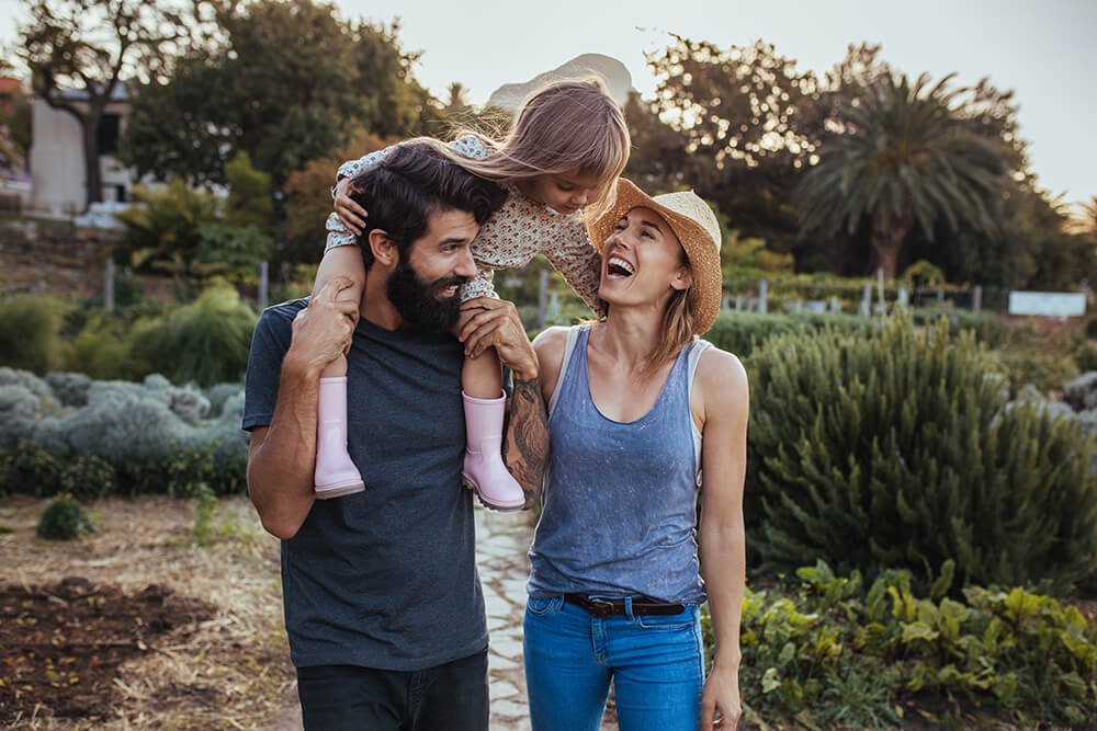 Happy Couple With Their Daughter After Receiving Treatment