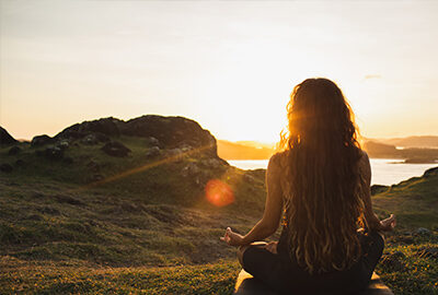 woman sitting watching sunset