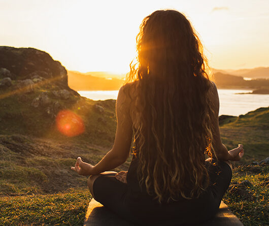 woman sitting watching sunset