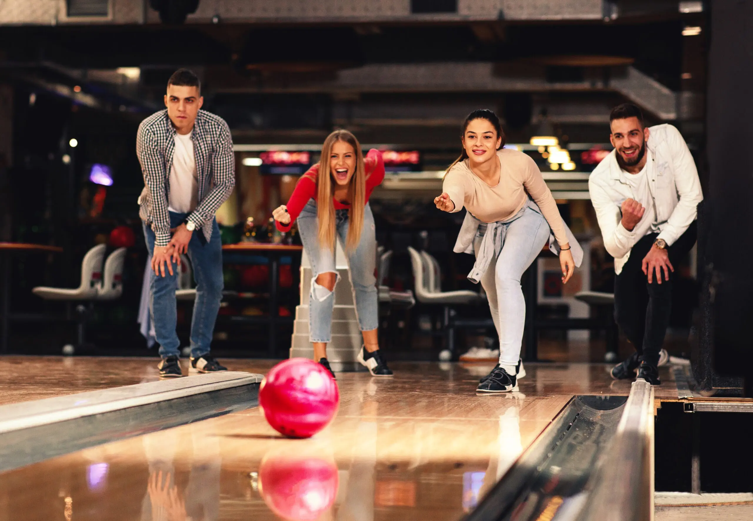A group of people bowling together