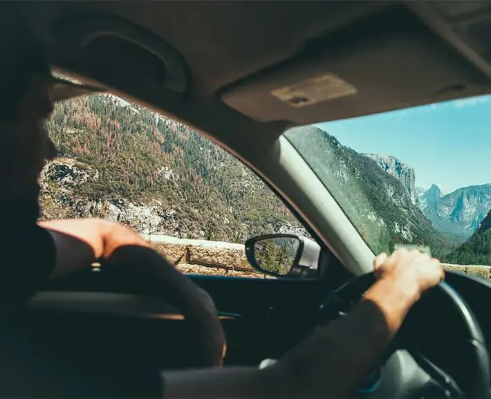 An image of a driver in a car after obtaining their license back after a DUI