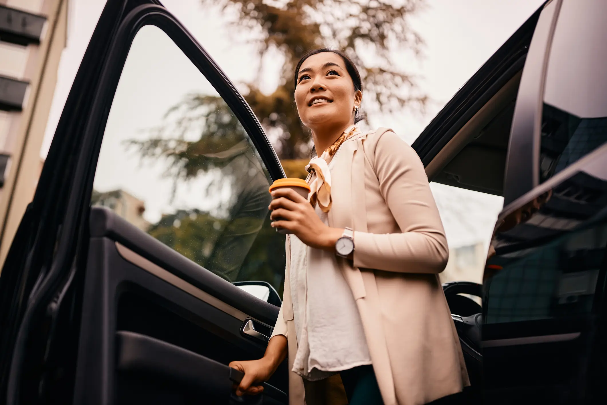 Women getting out of a car with a coffee to begin a day of treatment