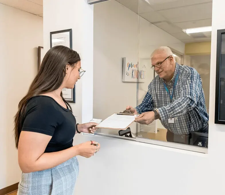 Patient checking in at a counter for an outpatient session